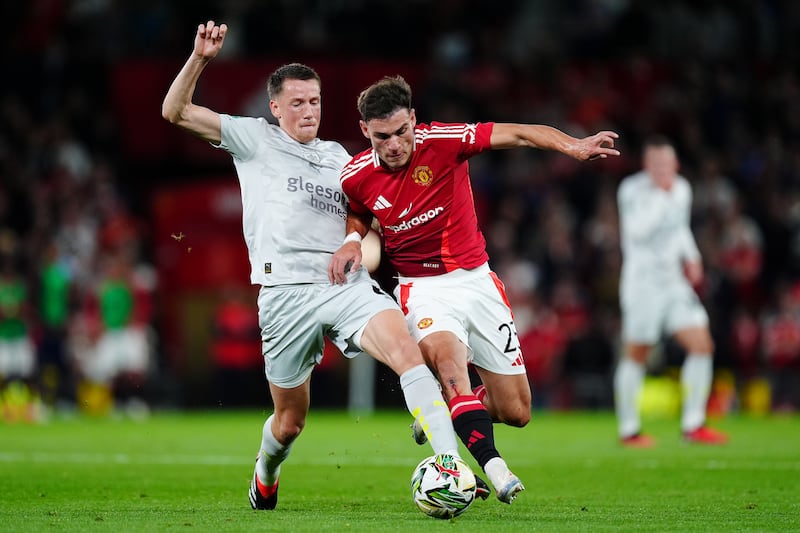 Barnsley’s Mael de Gevigney (left) and Manchester United midfielder Manuel Ugarte battle for the ball during Tuesday’s Carabao Cup clash