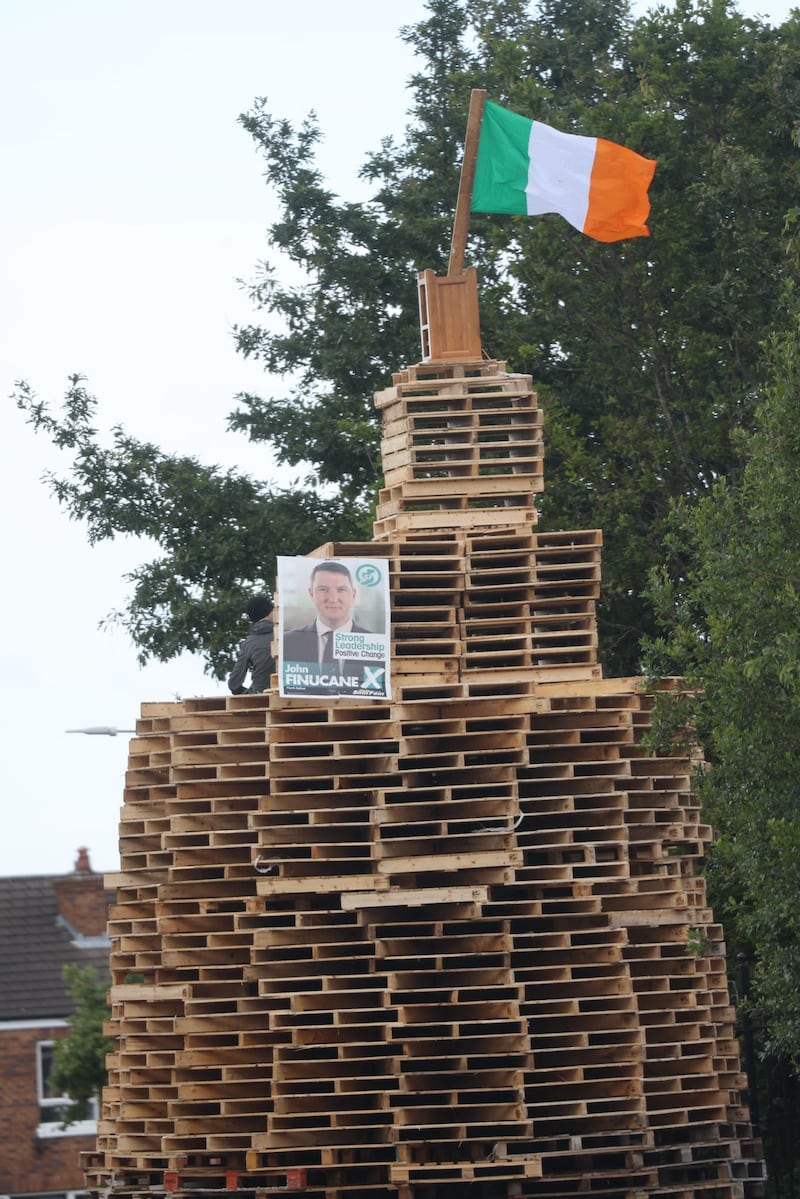 A bonfire in the Tigers Bay area of Belfast, featuring a Sinn Féin election poster and an Irish tricolour.