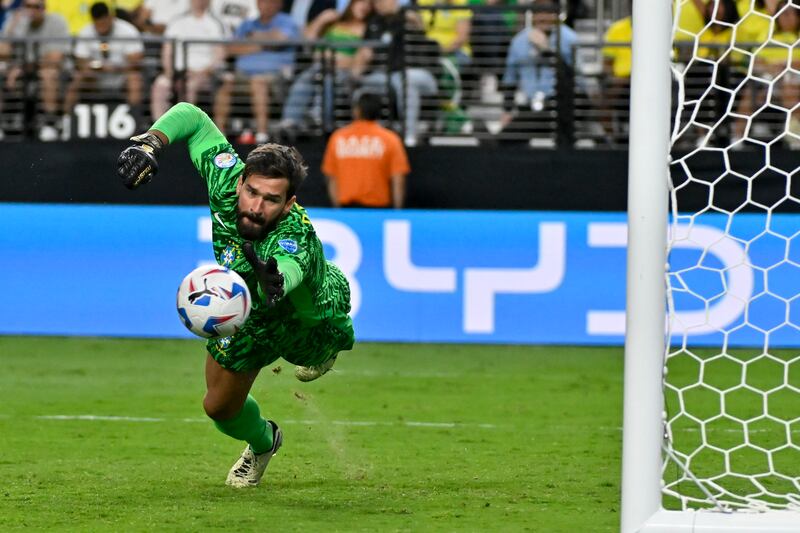 Brazil’s goalkeeper Alisson stretches out for a save attempt (David Becker/AP)