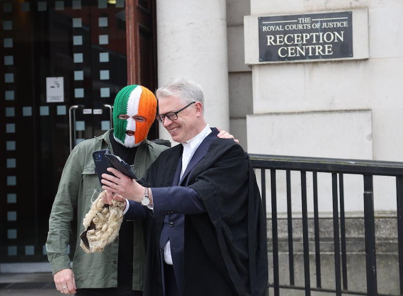 Belfast rap group Kneecap member DJ Próvaí gets a selfie with  Barrister Joe Brolly  At Belfast High Court on Thursday. Kneecap took legal action after it was blocked from getting a £15,000 grant.
PICTURE COLM LENAGHAN