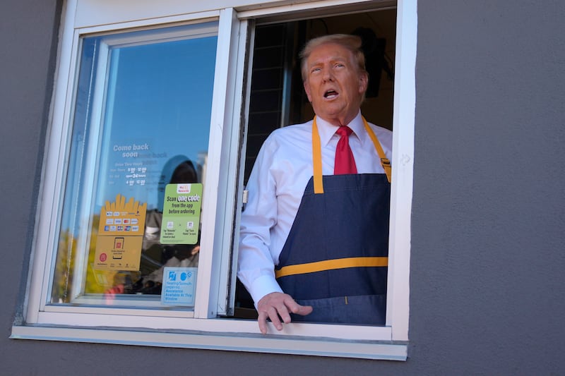 Donald Trump speaks from a drive-thru window (Evan Vucci/AP)