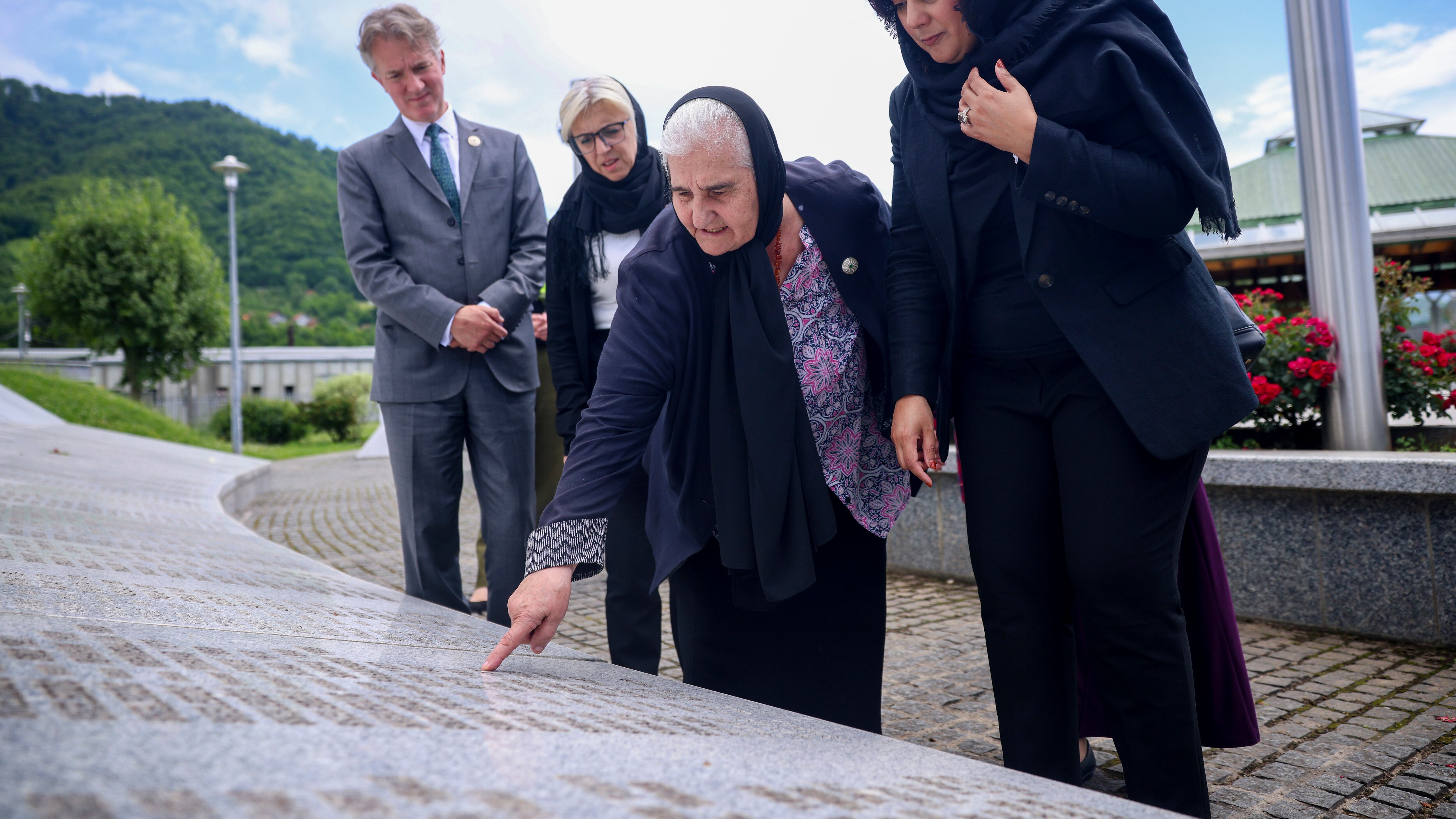 UK Minister of State (Minister for Europe) Nusrat Ghani, right, walks with Munira Subasic, president of the association Mother of Srebrenica, centre, next to the momument with the names of Srebrenica genocide victims, at the Memorial Centre in Potocari, Bosnia (Armin Durgut/AP)