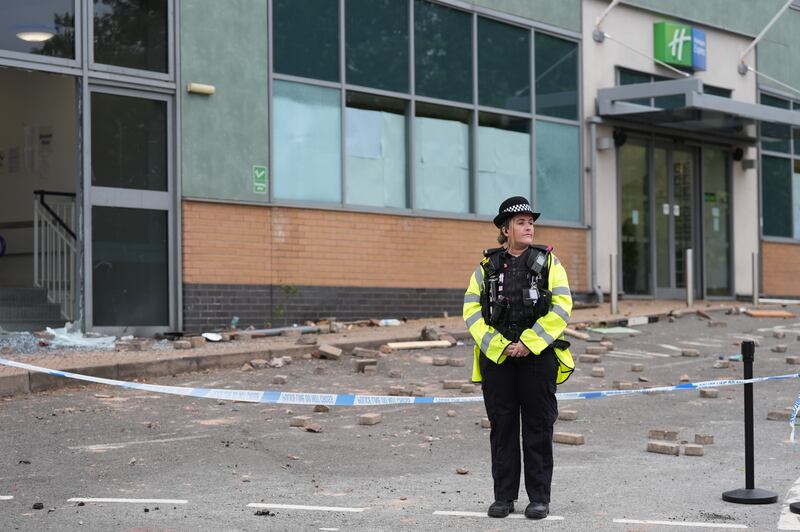 Police at the Holiday Inn Express in Tamworth after a mob attacked it on Sunday