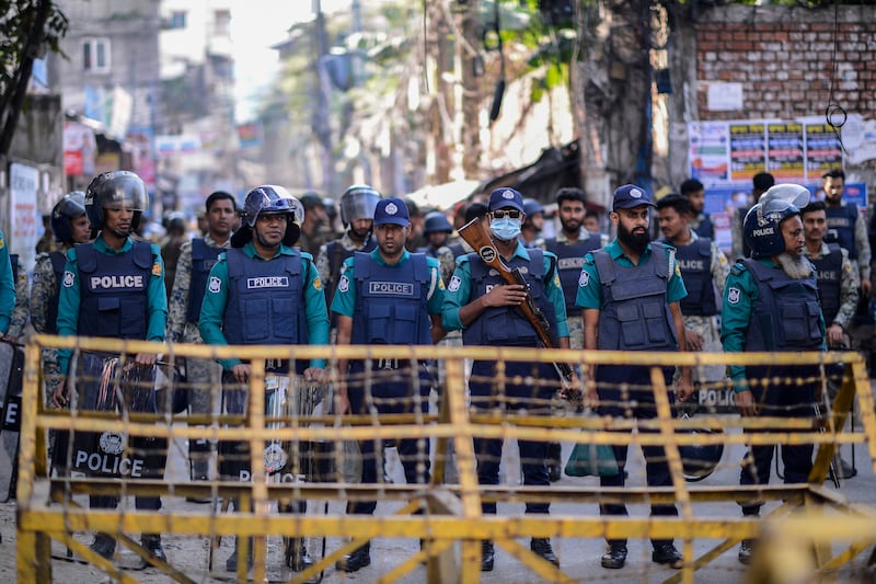 Police officers stand guard outside the Indian High Commission in Dhaka, Bangladesh (Mahmud Hossain Opu/AP)