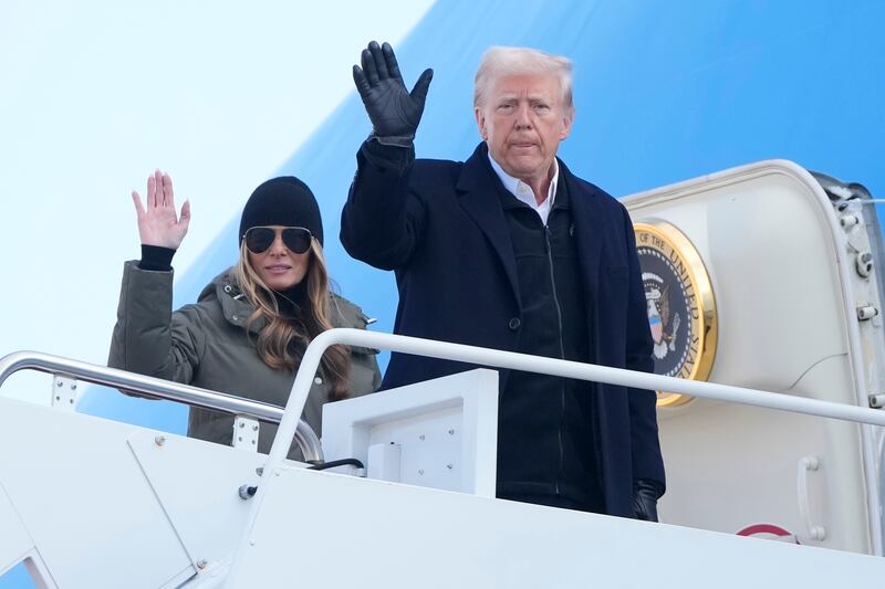 President Donald Trump and first lady Melania Trump wave as they board Air Force One (Mark Schiefelbein/AP)