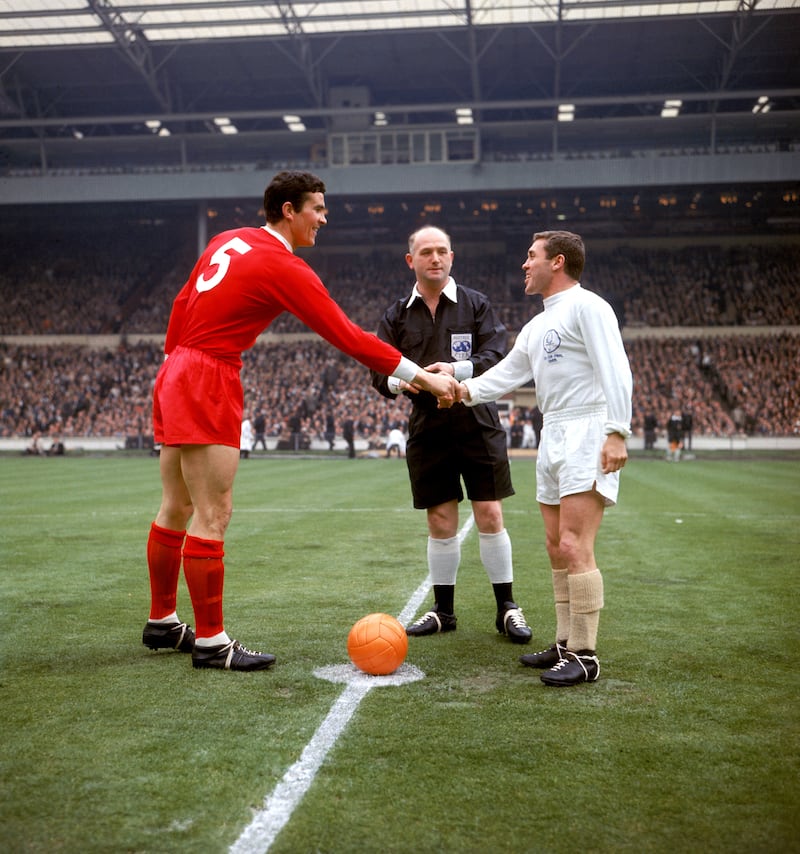 Bill Shankly’s ‘colossus’ Ron Yeats (left) was the first Liverpool captain to lift the FA Cup after beating Leeds – captained by Bobby Collins – in the 1965 final