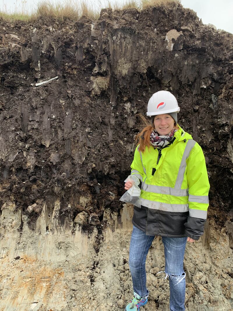 Dr Zoe Thomas in front of a cross-section of Falklands peat