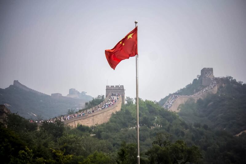 The Great Wall of China near Beijing on a summer day with the Chinese flag flying
