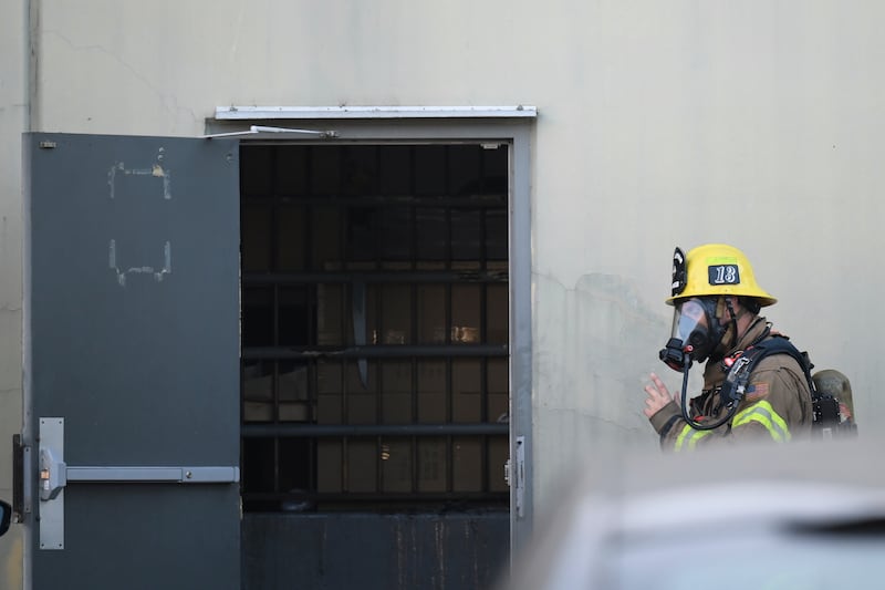 A firefighter enters a building where the plane crash occurred in Fullerton, California (Kyusung Gong/AP)