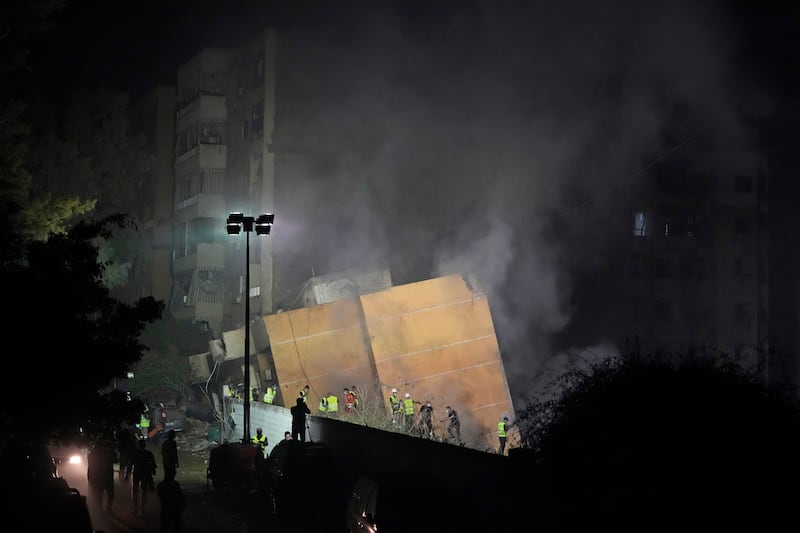 Rescuers at the site of an Israeli air strike in Beirut’s southern suburbs (Hassan Ammar/AP)