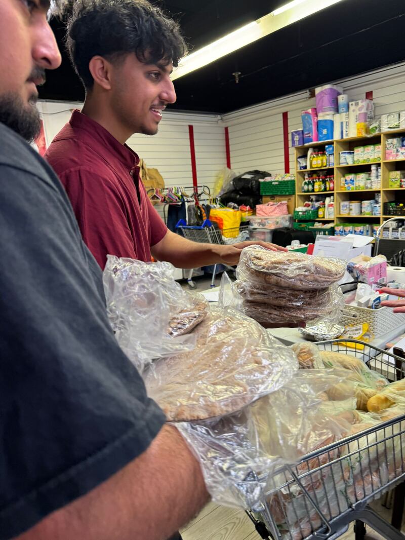 Omar Ahmad (left) and Zaki Ahmedi (right) delivering roti breads to a food bank in Bordon, East Hampshire