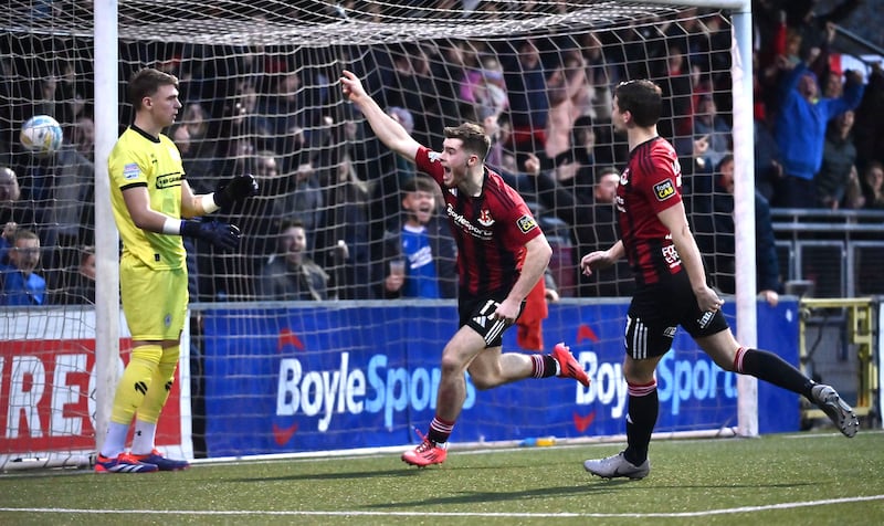 Kevin Offord wheels away in celebration after scoring his second gaol against North Belfast rivals Cliftonville