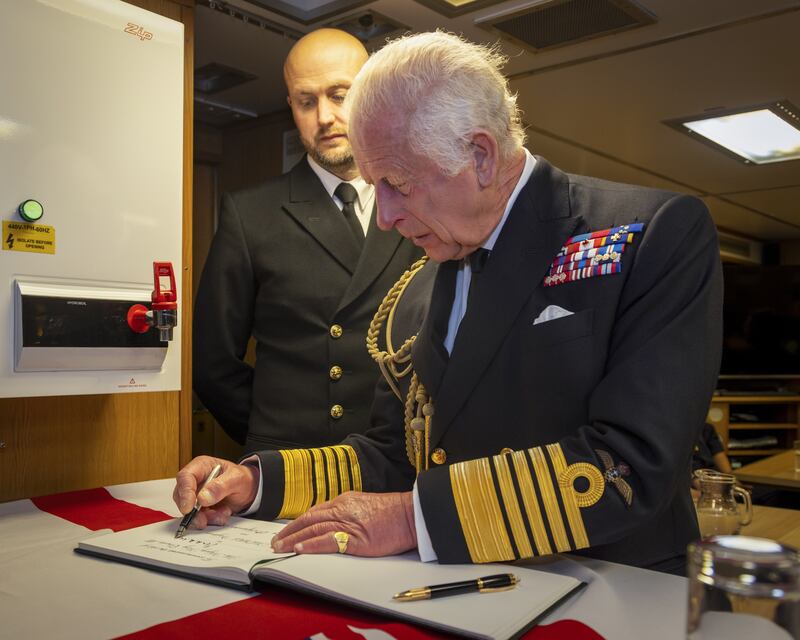 The King signing the visitors’ book during a visit to the Royal Naval Armaments Depot at Coulport