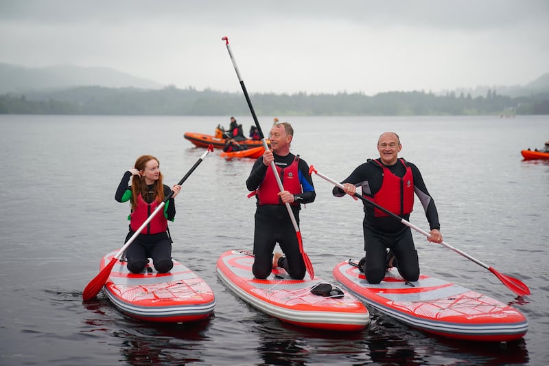 Liberal Democrat leader Sir Ed Davey (right) paddleboards on Windermere with Westmorland and Lonsdale MP Tim Farron and his daughter Gracie