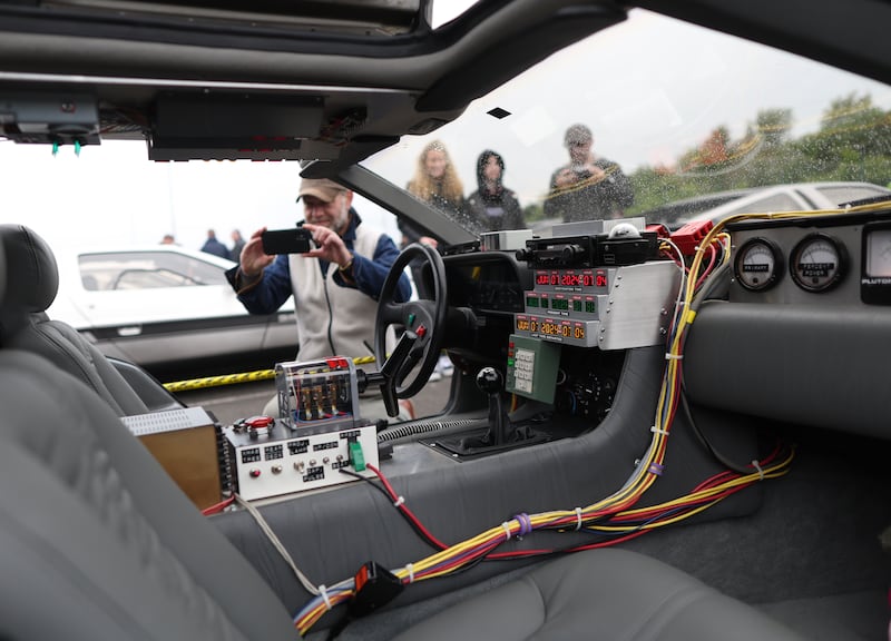 DeLorean owners gather at the Cutts in Dunmurry on Sunday as they drive on the old test track as part of the DeLorean Revival in Belfast.
PICTURE COLM LENAGHAN