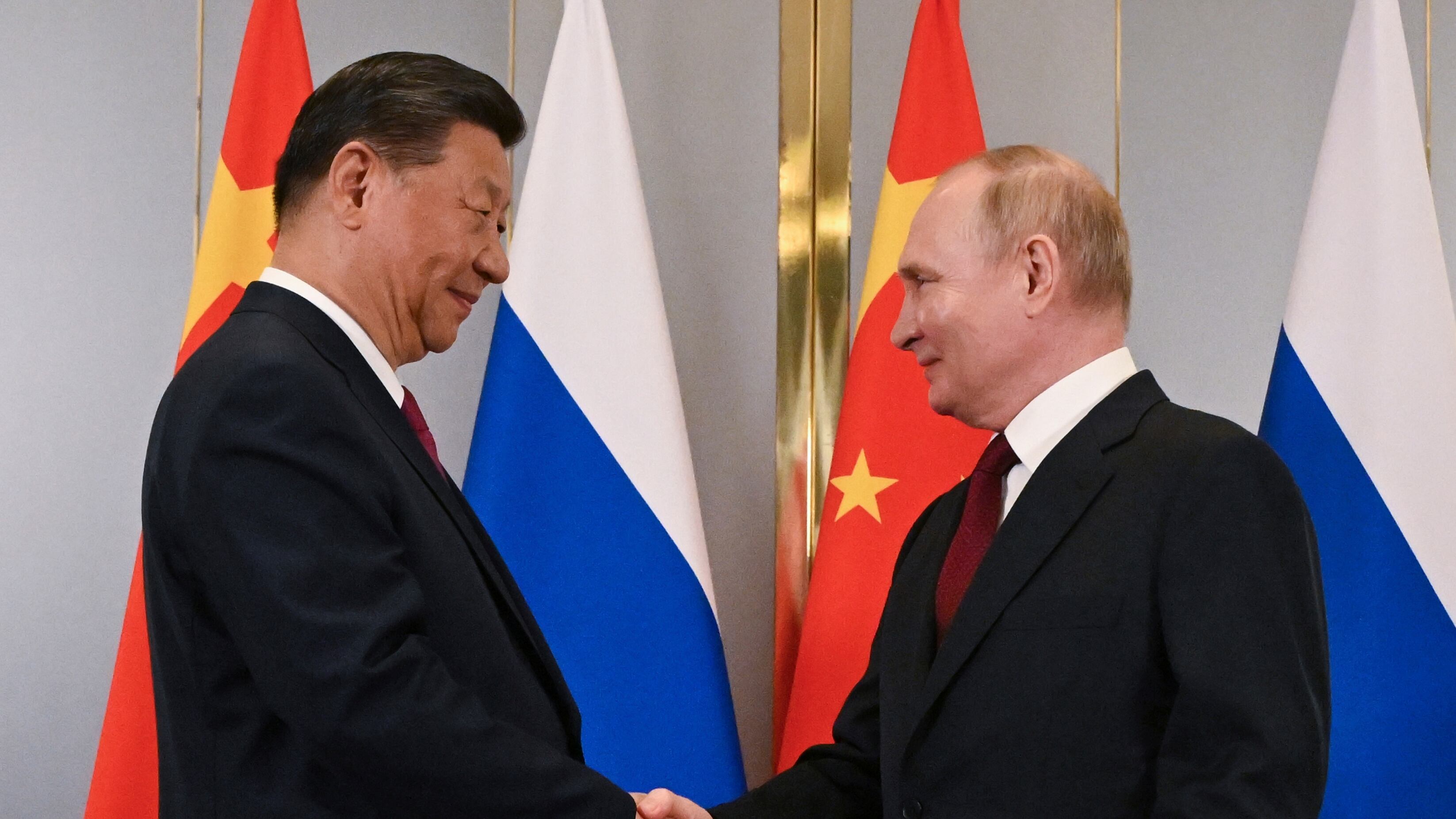 Russian President Vladimir Putin, right, and Chinese President Xi Jinping shake hands during their meeting on the side-lines of the Shanghai Co-operation (Sergey Guneyev, Sputnik, Kremlin Pool Photo via AP)