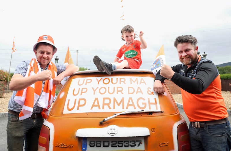 Armagh Fans Danny and  Johnny Mullan with Patrick , The Mullan family painted a car for the All Ireland.
PICTURE COLM LENAGHAN