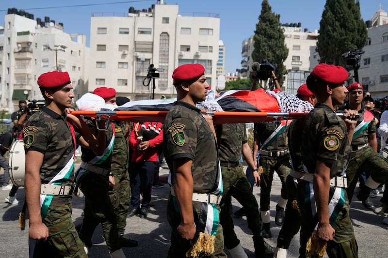 A Palestinian honor guard carries the body of Aysenur Ezgi Eygi (Nasser Nasser/AP)