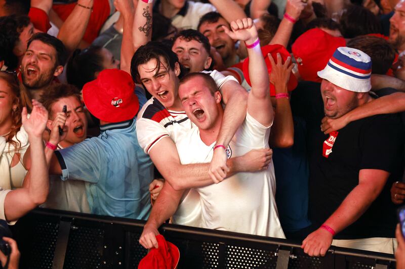 England fans celebrate at BOXPark Wembley in London after a screening of the Euro 2024 semi-final match between England and the Netherlands