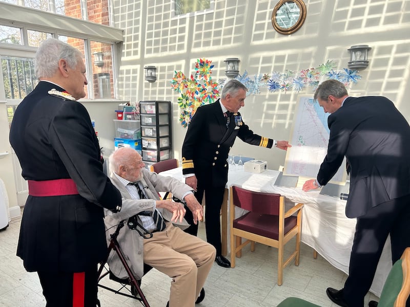 D-Day veteran Lieutenant Richard Willis RN is presented with a D-Day chart of the Utah beach landings to mark his 100th birthday