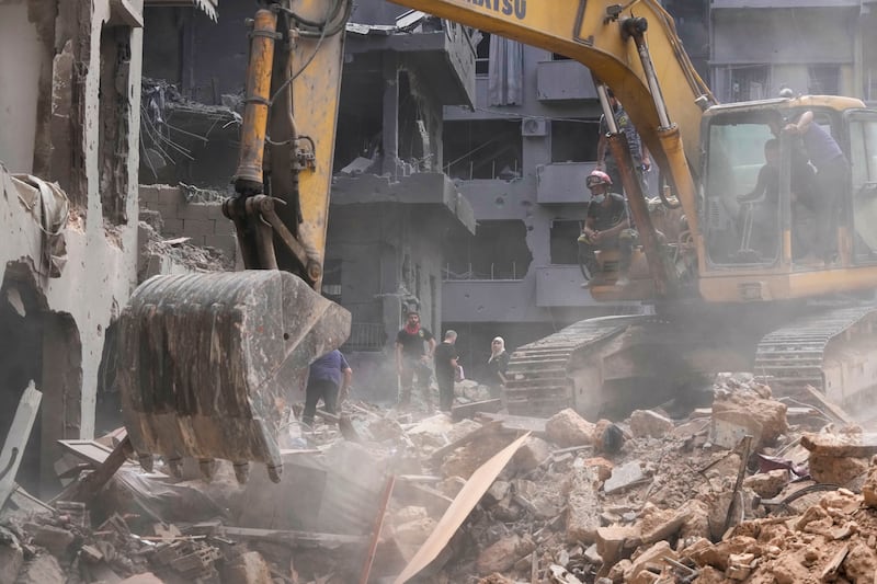 Rescue workers searching for victims at the site of an Israeli air strike in Beirut, Lebanon (Hassan Ammar/AP)