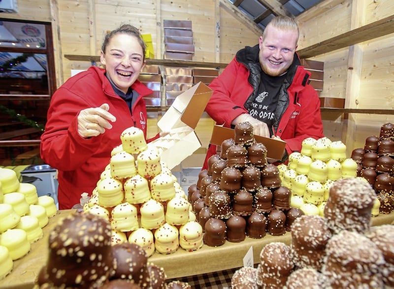 Kayleigh Ward and Matthew Green on their chocolate stall at the Christmas Market in the grounds of Belfast City Hall. Picture by Mal McCann 