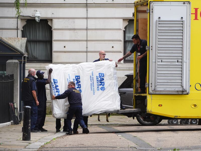 Removal men carrying a mattress out of Downing Street