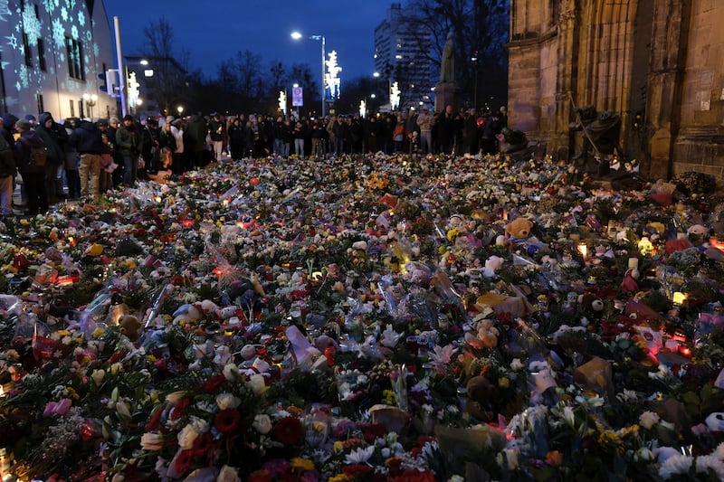 Flowers and candles close to the Christmas market in Magdeburg (Sebastian Willnow/dpa/AP)