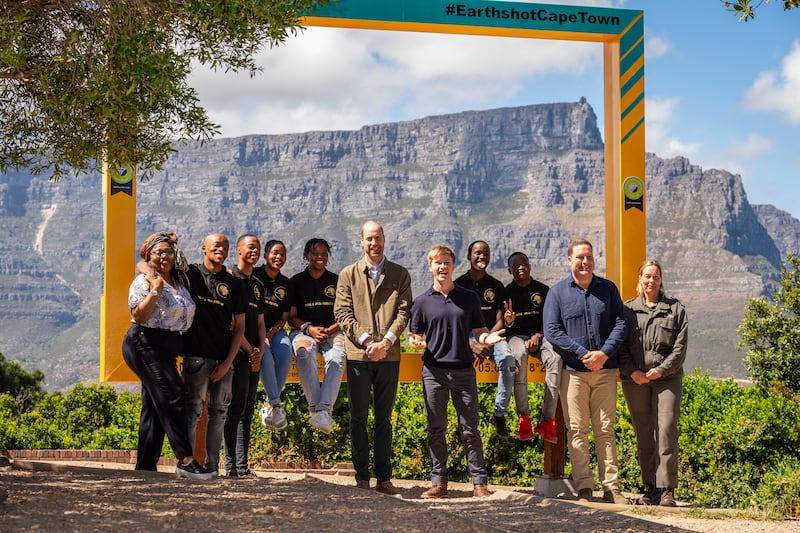 The Prince of Wales with youth conservation volunteers, Earthshot Prize Global Ambassador Robert Irwin and Geordin Hill-Lewis, Mayor of the City of Cape Town, during a visit to Signal Hill