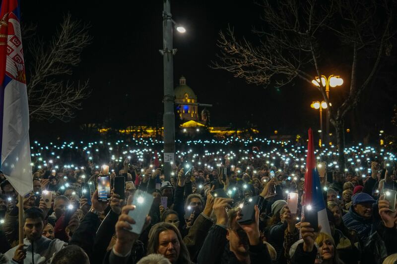 Protesters outside the electoral commission building in Belgrade (Darko Vojinovic/AP)