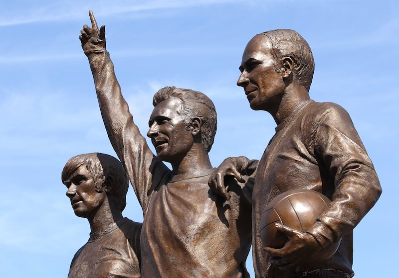 Denis Law flanked by George Best (left) and Bobby Charlton (right)