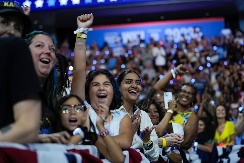 Supporters cheer as Kamala Harris and Tim Walz arrive at a campaign rally in Philadelphia (Matt Rourke/AP)