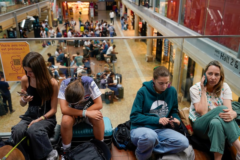 Travellers wait inside the Gare de Bordeaux Saint-Jean (Moises Castillo/AP)