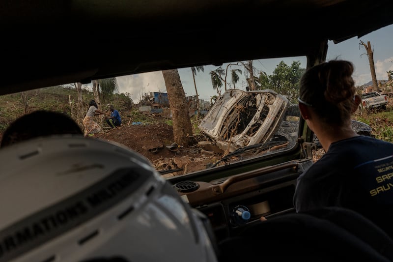 Broken cars litter the road in Mirereni, Mayotte (Adrienne Suprenant/AP)