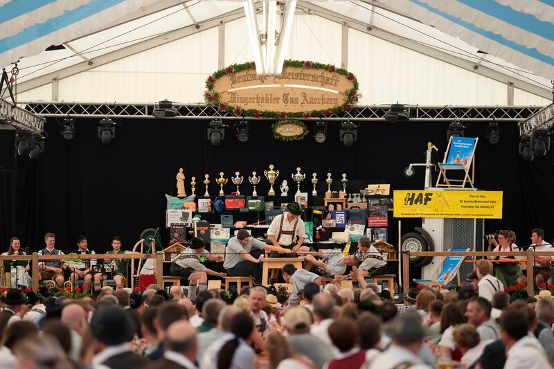The contest takes place in a large beer tent filled with onlookers dressed in traditional clothes (Matthias Schrader/AP)