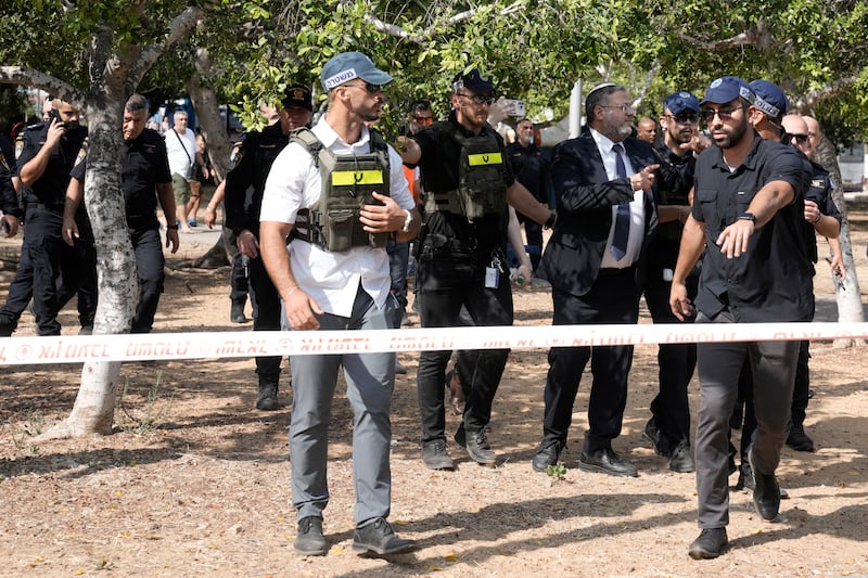 Israeli national security minister, Itamar Ben-Gvir, second from right, visiting the scene of the stabbing (Mahmoud Illean/AP)