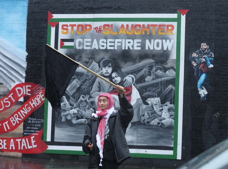 Supporters of the Palestinian people hold a black flag protest at the Murals on the Falls Road in West Belfast.
PICTURE COLM LENAGHAN