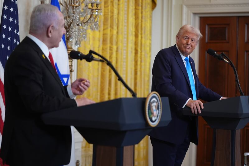 US President Donald Trump listens as Israel’s Prime Minister Benjamin Netanyahu speaks during a news conference in the East Room of the White House (Evan Vucci/AP)