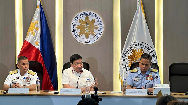 Philippines security officials (L to R) Roy Trinidad, Jonathan Malaya, and Jay Tarriela hold a news conference in Manila (Joeal Calupitan/AP)