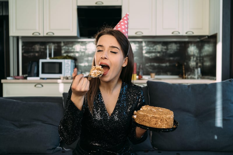 Young woman eating delicious cake