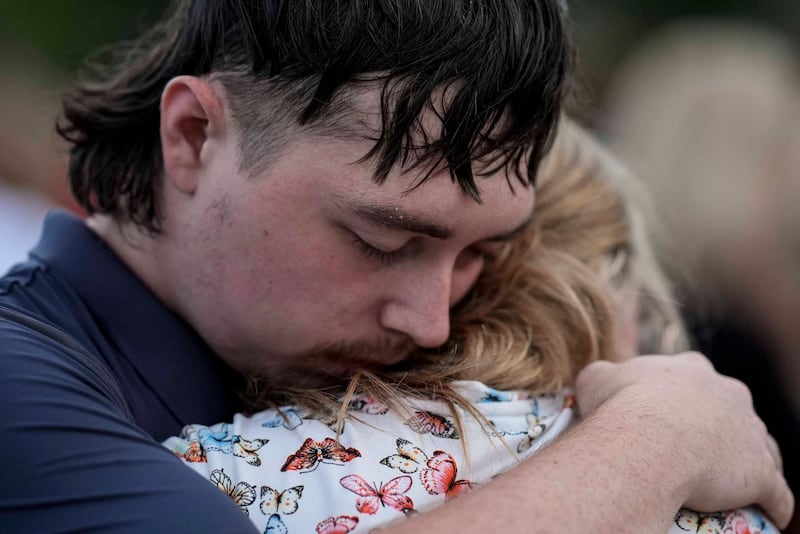 Mourners pray during a candlelight vigil for the students and teachers killed at Apalachee High School in Georgia Mike Stewart/AP)