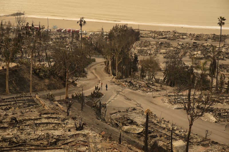 Residents have been urged to stay away from their homes and the rubble, warning that it may contain harmful chemicals (John Locher/AP)