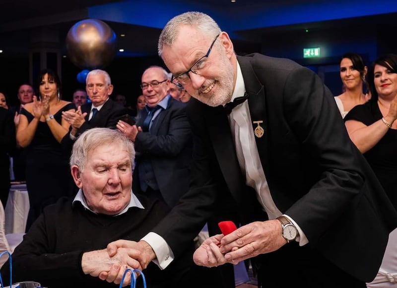 GAA Uachtarain Larry McCarthy present Brian Seeley with a gold medal at Clan na Gael's centenary dinner two years' ago