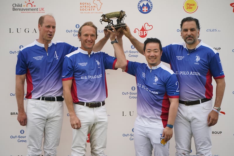 The Prince of Wales and his teammates (left to right) Mark Tomlinson, Aiyawatt Srivaddhanaprabha and Amr Zedan were presented with a trophy