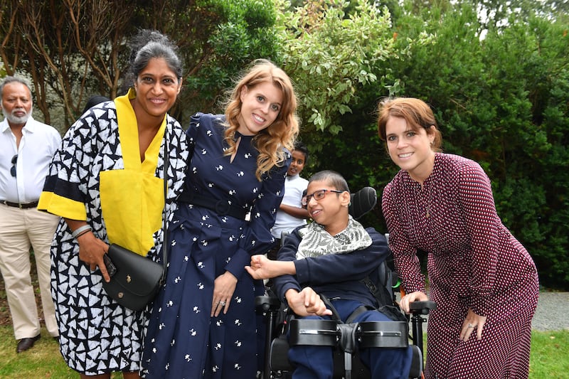 Princesses Beatrice and Eugenie with Sheema Luca and her son Massimo Luca during a garden party at Haven House Children’s Hospice, Woodford Green