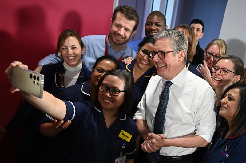 Prime Minister Sir Keir Starmer takes a selfie with members of NHS staff at the end of a visit to the Elective Orthopaedic Centre in Epsom