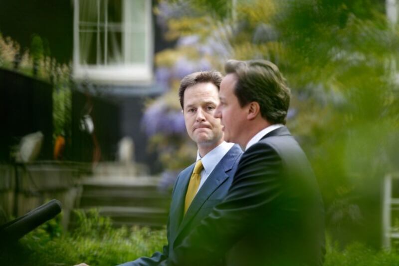 Prime Minister David Cameron (right) and Deputy Prime Minister Nick Clegg hold their first joint press conference in the Downing Street garden in central London.