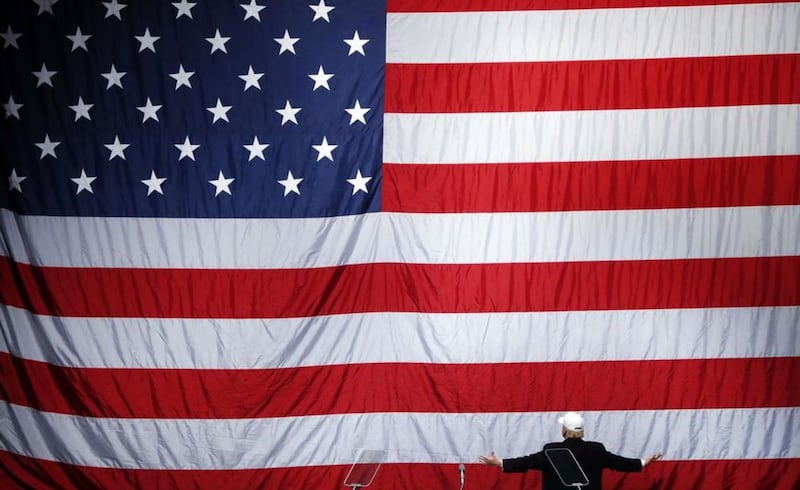 Donald Trump looks at the American flag at a campaign rally in Michigan on Sunday. Picture by Paul Sancya, Associated Press 