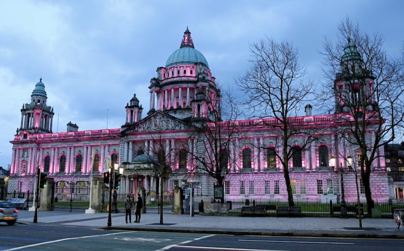 Belfast City Hall was lit up pink last night as part of a campaign calling for better mental health services. Picture by Philip Walsh. 