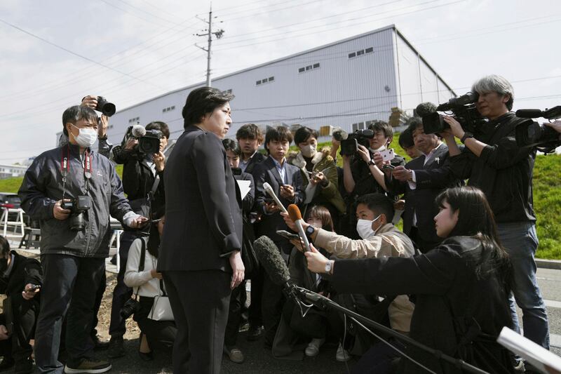 An employee of Kobayashi Pharmaceutical speaks to the media outside a plant operated by its subsidiary in Kinokawa (Yohei Fukai/Kyodo News/AP)